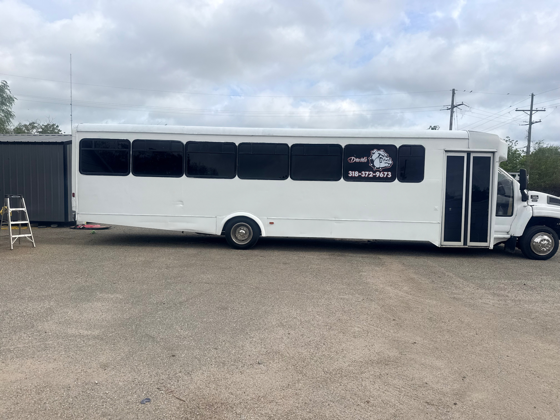 Side view of the white 35 passenger David's party bus